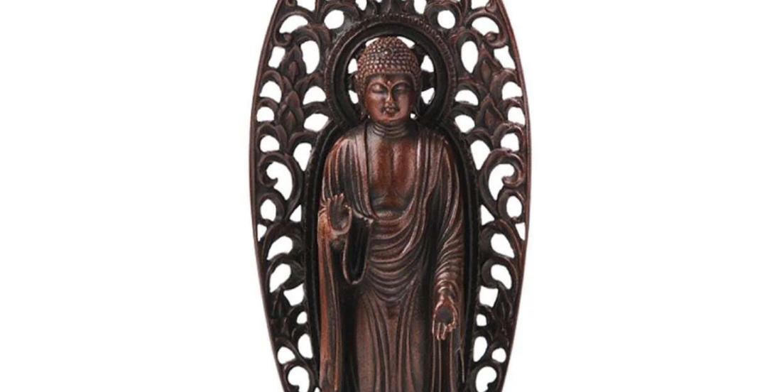 Standing Buddha statue with an ornate halo and symbolic hand gestures, illustrating visual features used to distinguish Amida Nyorai from Shaka Nyorai in Japanese Buddhist art.