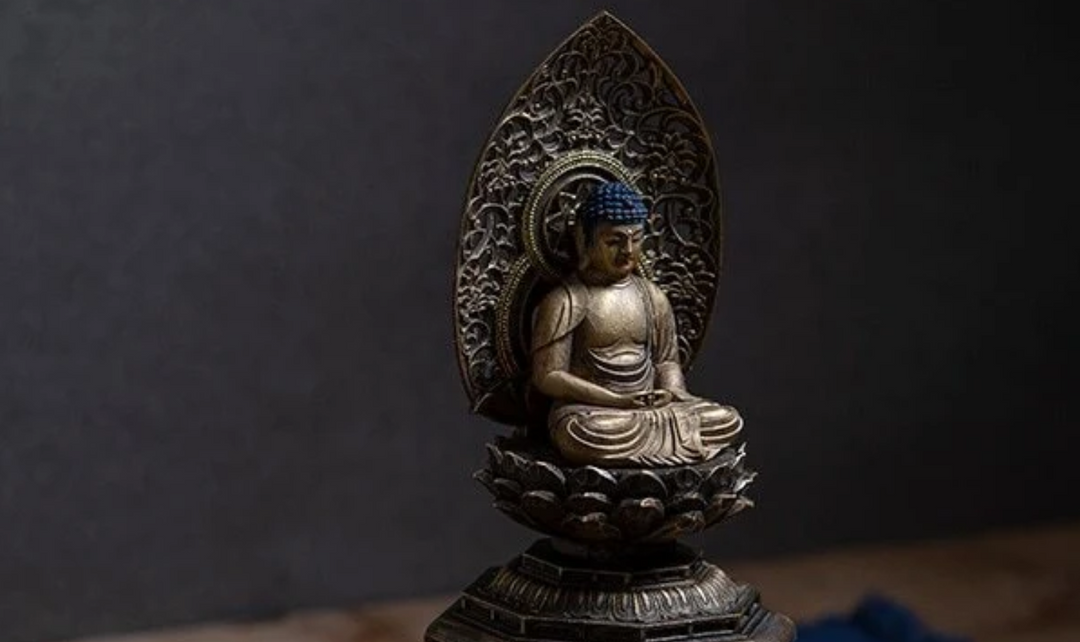 Amitabha Buddha statue seated on a lotus pedestal with an ornate halo, symbolizing divine light, spiritual radiance, and the Pure Land tradition.