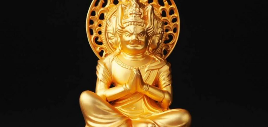 Golden Bato Kannon statue with hands joined in prayer and a fierce horse-headed form, representing compassionate protection in Japanese Buddhism.