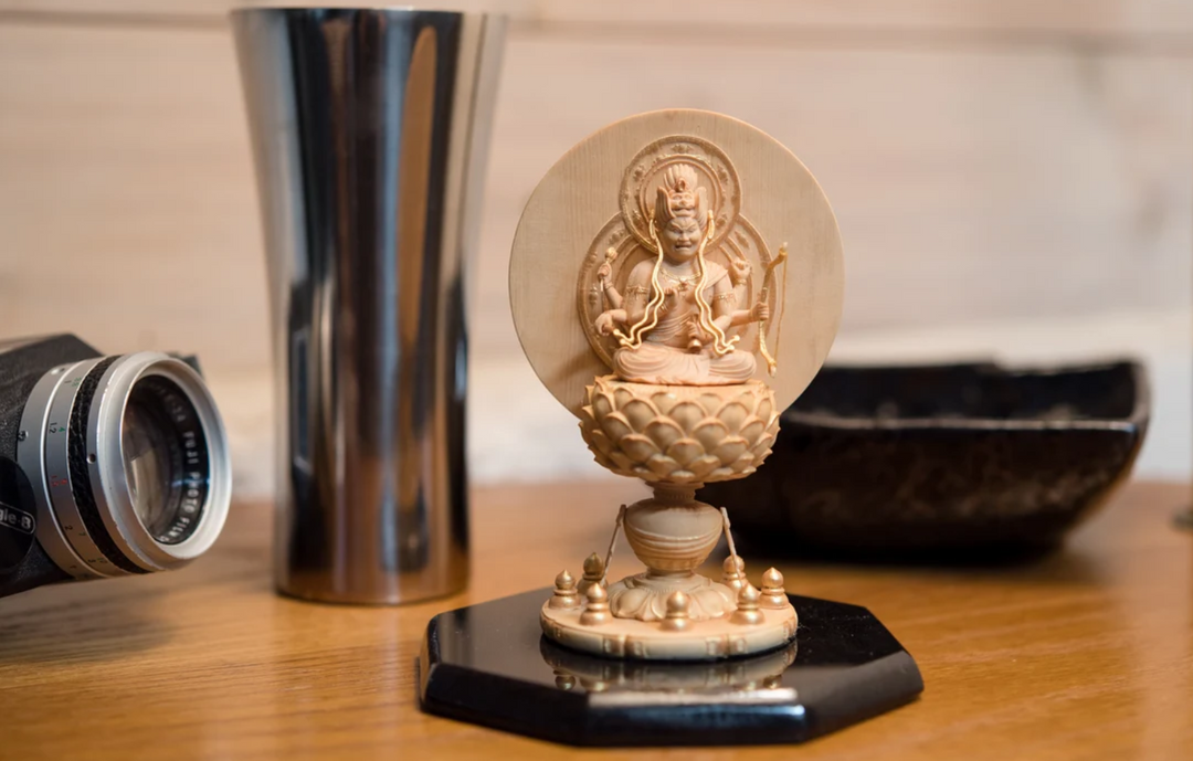 Buddhist statue displayed on a tabletop in a home interior, illustrating considerations for facing a statue toward the room, entrance, or altar.