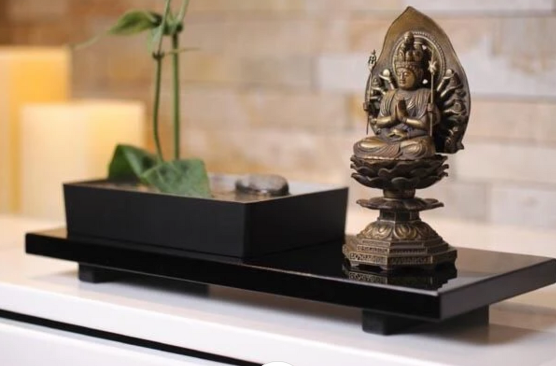 Multi-armed Guanyin statue displayed in a peaceful home setting, illustrating the bodhisattva’s distinctive iconography and compassionate role in Buddhism.