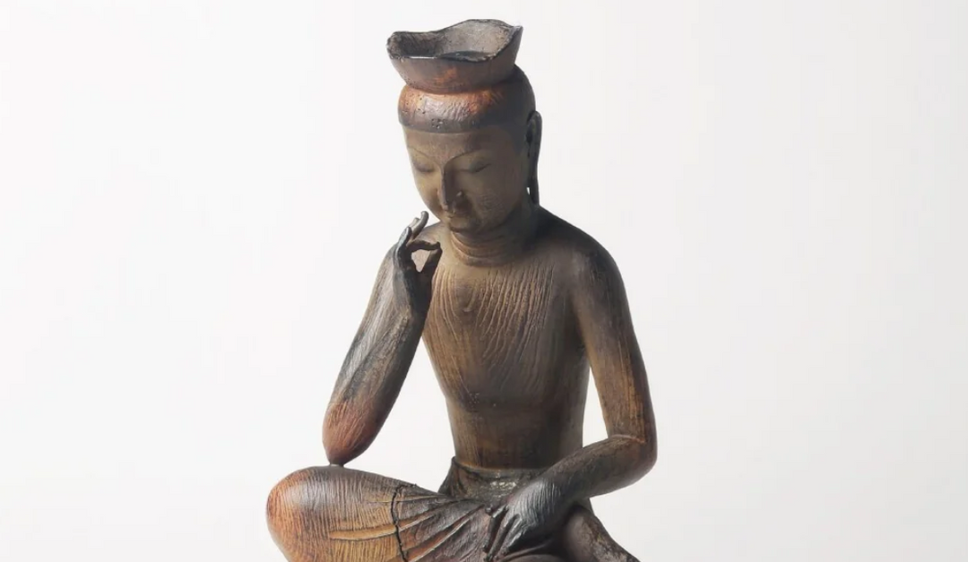 Seated Maitreya statue with a calm expression and symbolic hand gesture, representing the future Buddha in Buddhist tradition.