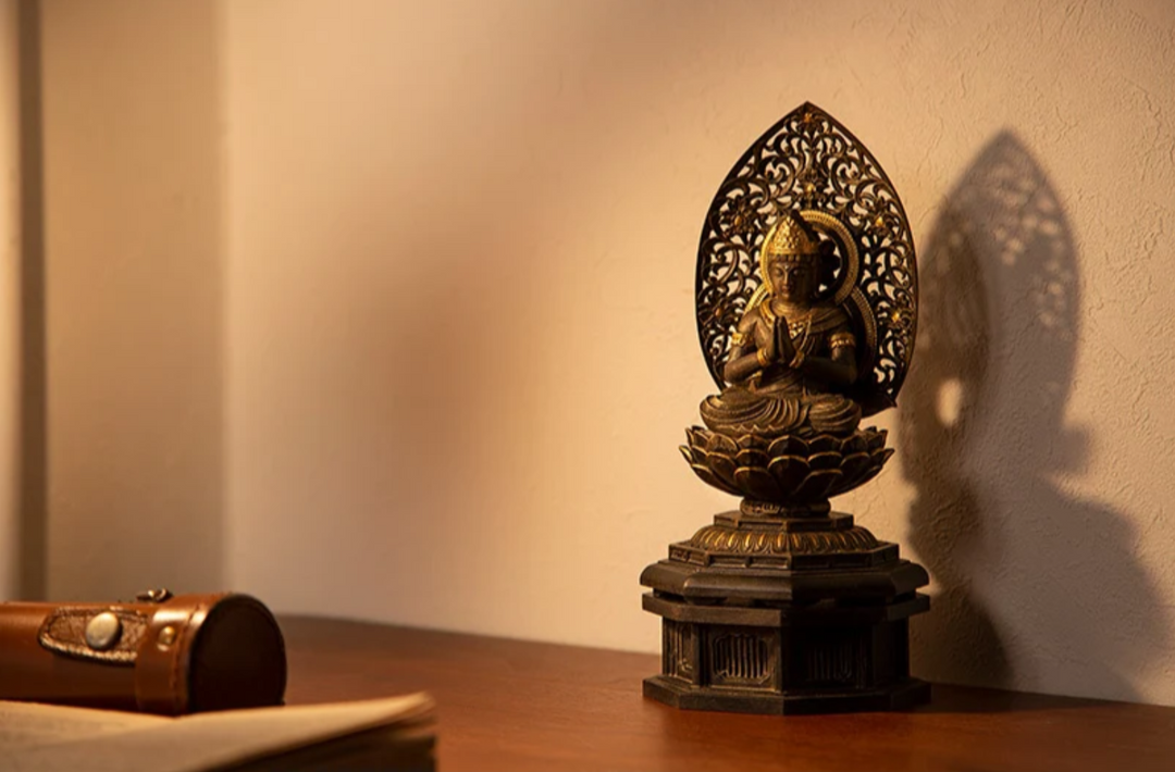 Seishi Bosatsu statue seated on a lotus pedestal with hands joined in prayer, displayed in warm light and representing Amitabha Buddha’s attendant in Japanese Buddhism.