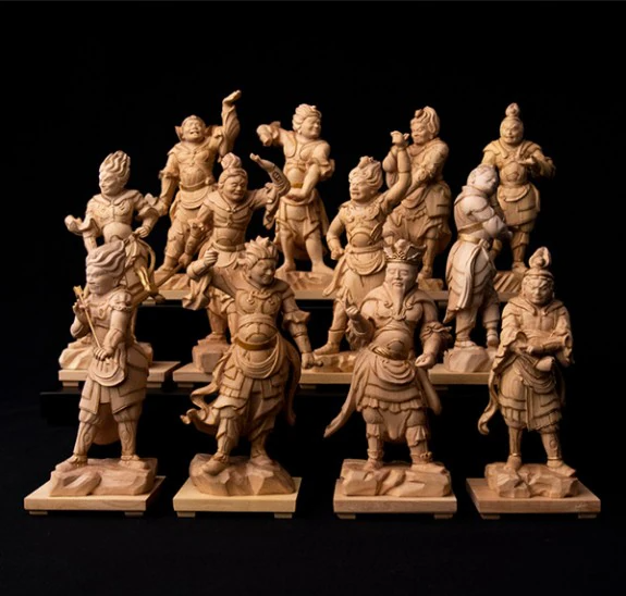 Wooden Twelve Divine Generals statue set with 12 carved guardian figures displayed against a black background