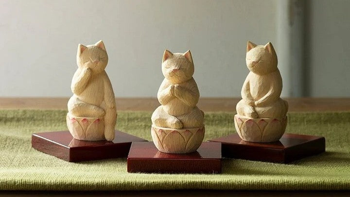 Set of three wooden see-no-evil, speak-no-evil, hear-no-evil monkey figurines sitting on lotus bases